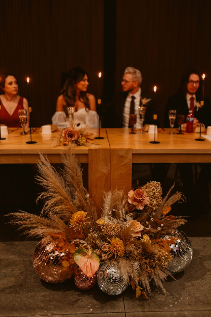 A wedding party seated at a head table at The Harper.