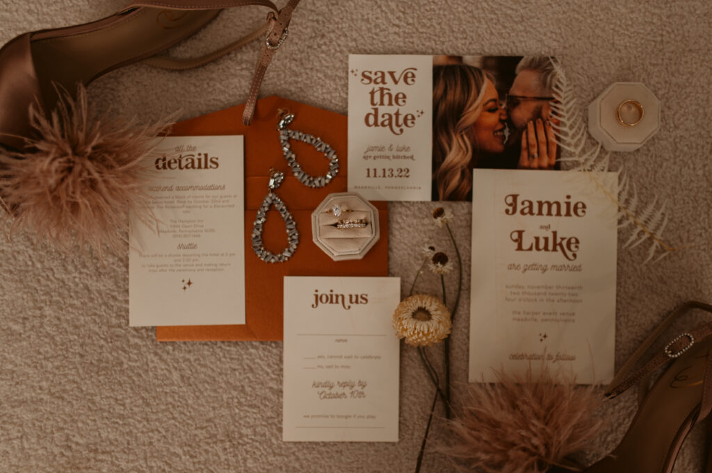 Wedding flatlay of Jamie and Luke's save the date, join us and details
